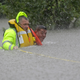 Wilford Martinez, right, is rescued from his flooded car along Interstate 610 on Aug. 27 in Houston.